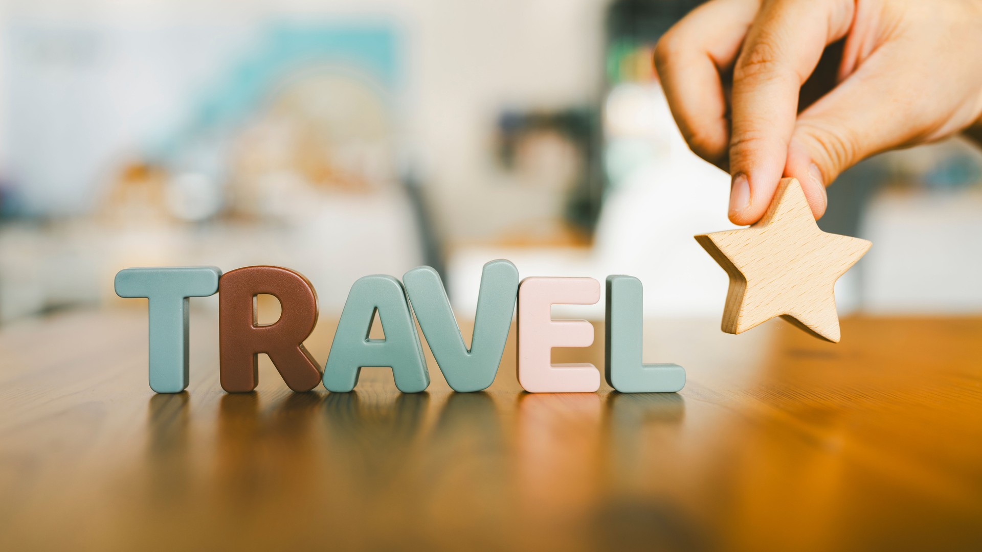 Businessman's hand is holding a star with the letters Travel, a concept for rating tourist attractions and exploring tourist spots.