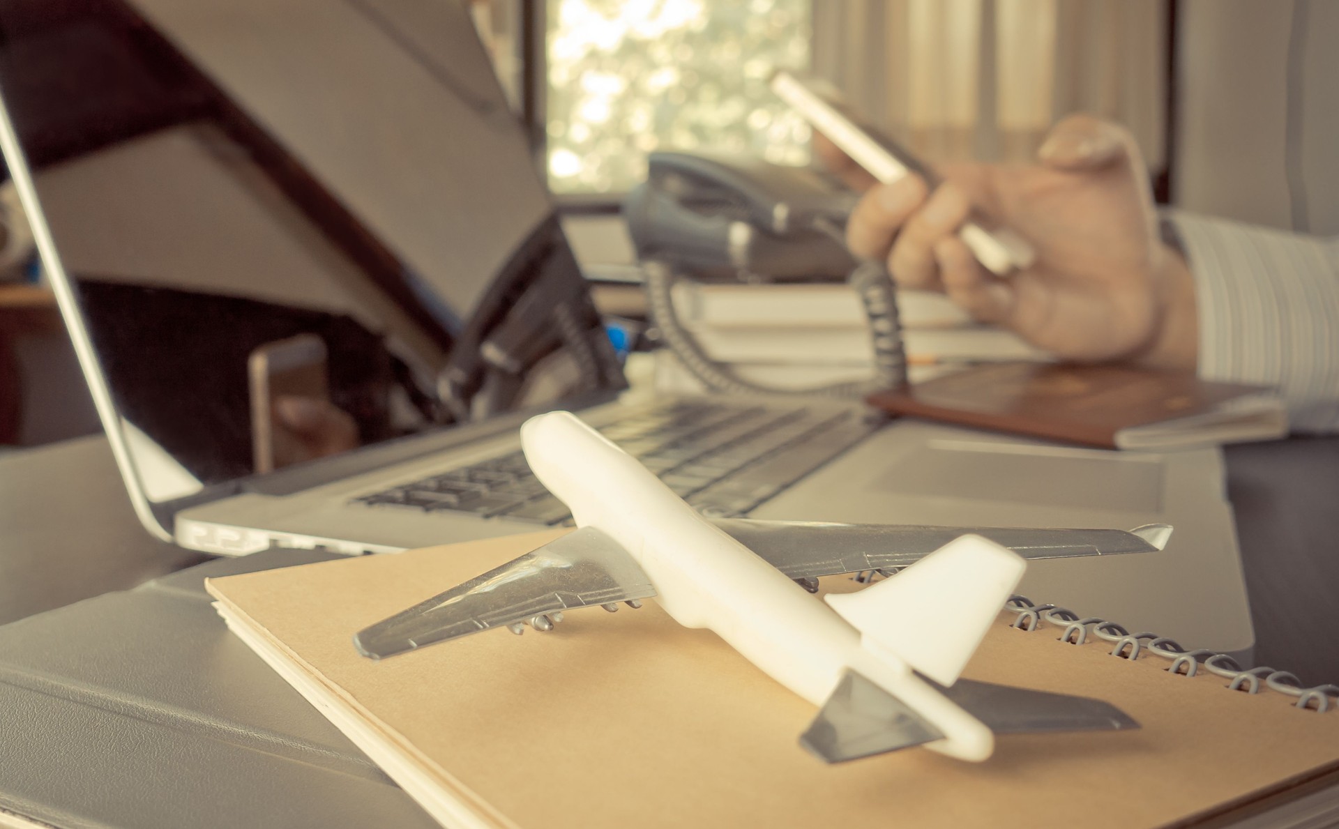 Travel agency using phone in office working desk